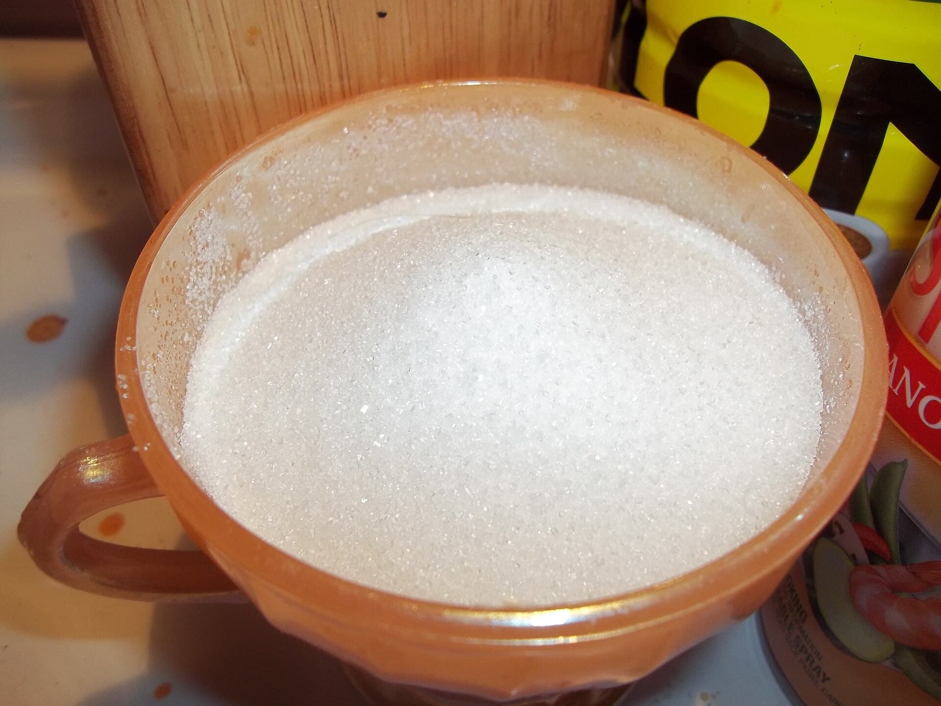 White mill sugar filling a stoneware bowl